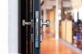 Open unlocked doors in an empty secure vacant corporate business area, nobody, door knob lock side closeup. Door left open, office Royalty Free Stock Photo