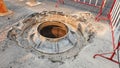 Open unsecured sewer manhole on the asphalt road