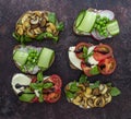 Open vegetarian toasts with different toppings, top view. Flat lay of rye bread crostini Royalty Free Stock Photo