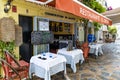 Open verandas of street summer cafes with tables with white tablecloths in Malaga Old Town