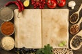 Open vintage book with spices on wooden background. Healthy vegetarian food. Recipe, menu, mock up, cooking. Royalty Free Stock Photo