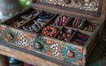 An open vintage jewelry box filled with colorful beads and necklaces, artistic treasures. Royalty Free Stock Photo