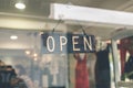 Open sign broad through the glass of store window. Asia. Royalty Free Stock Photo