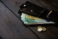 Open wallet with Euro cash and Euro cents on wooden background Royalty Free Stock Photo