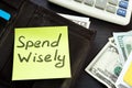 Open wallet with memo spend wisely. Money habits. Royalty Free Stock Photo