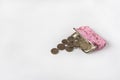 open wallet with scattered coins on a white background Royalty Free Stock Photo