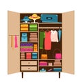 An open wardrobe with clothes neatly laid out on the shelves. Order in the wardrobe. Things in the closet on hangers. Reasonable