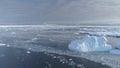 Open water glacier iceberg above speed flight view