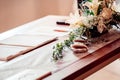 Open wedding registry book, on a wooden table, with flowery decoration, indoors Royalty Free Stock Photo