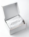 Open White Cardboard Box with White Fabric on Light Background Royalty Free Stock Photo