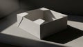 Open white cardboard box with folded flaps rests on a smooth gray Royalty Free Stock Photo