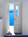 Open white door overlooking the sea and Caldera, famous door to nowhere Santorini, Greece Royalty Free Stock Photo