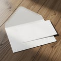 Open white envelope on a wooden surface displaying an unfolded sheet of paper. The Royalty Free Stock Photo