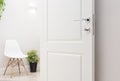 The open white interior doors. Modern chrome handle and lock wit Royalty Free Stock Photo