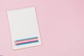 Open white notebook with light blue, pink, white colored pencils on pastel pink background. Top view, copy space for Royalty Free Stock Photo