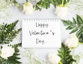 Open white notebook with white page in floral frame. Happy valentines day