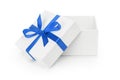 Open white textured gift box with blue ribbon bow