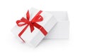 Open white textured gift box with red ribbon bow Royalty Free Stock Photo