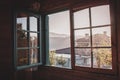 Open window with dirty glass in rural house. View from window to mountains. Interior of countryside building. Village architecture Royalty Free Stock Photo