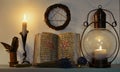 Open witch book with spells, old-fashioned lamp, candle and pentagram