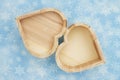 Open wood shaped box on blue snowflake textured material