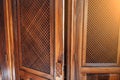 open wooden door with grating to the confessional for confession inside Catholic Cathedral Church close-up Royalty Free Stock Photo