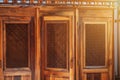 open wooden door with a grille to confessional booth for confession inside the Catholic church Royalty Free Stock Photo