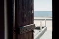 Open wooden door overlooking the sea on Santorini Royalty Free Stock Photo