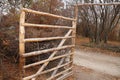 Open wooden gate made of sticks in the countryside Royalty Free Stock Photo