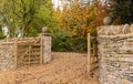 Open wooden gates at entrance to modern house