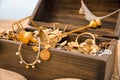 Open wooden treasure chest on sandy beach, closeup Royalty Free Stock Photo