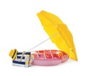 Open yellow beach umbrella, inflatable ring and accessories on white background Royalty Free Stock Photo