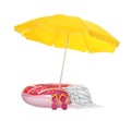 Open yellow beach umbrella, inflatable ring, blanket and flip flops on white background Royalty Free Stock Photo