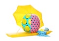 Open yellow beach umbrella, inflatable ring, mattress, towel and hat on white background Royalty Free Stock Photo