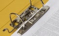 Open yellow binder close up, stack of white papers and bright metal rings Royalty Free Stock Photo