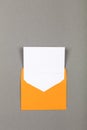 Open yellow paper envelope over grey