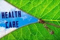 Health care word under zipper leaf