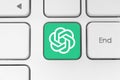 OpenAI ChatGPT icon key on white computer keyboard close-up. Concept of using the artificial intelligent services in business and