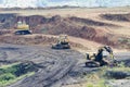 Opencast mining quarry with lots of machinery at work