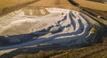 Opencast mining quarry with machinery at work - Aerial view. Industrial Extraction of lime, chalk, calx, caol Royalty Free Stock Photo