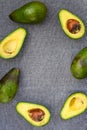 Opened avocado showing seed on textured grey linel background. Top view, Copy space