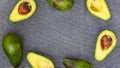 Opened avocado showing seed on textured grey linel background. Top view, Copy space