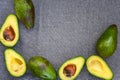 Opened avocado showing seed on textured grey linel background. Top view, Copy space