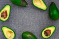 Opened avocado showing seed on textured grey linel background. Top view, Copy space