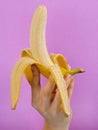 Opened banana in hand