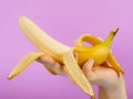 Opened banana in hand
