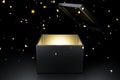 Opened black box with gold light inside, on dark background with falling sparkle, Christmas and anniversary concept Royalty Free Stock Photo