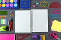 Opened blank notebook with school supplies frame on chalkboard