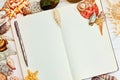 Opened blank notebook surrounded by sea shells Royalty Free Stock Photo