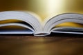 Opened book on a golden background. Close-up Royalty Free Stock Photo